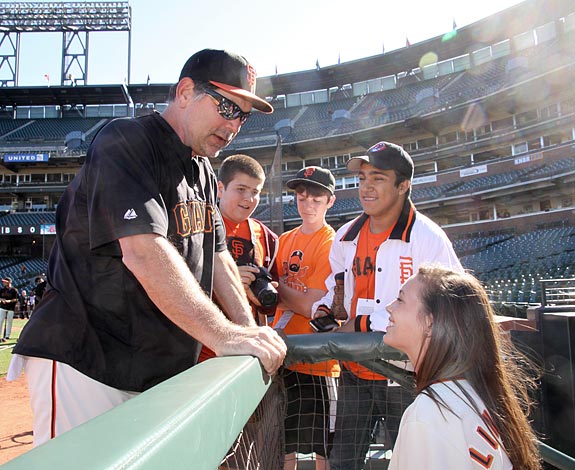 Image of San Francisco Giants manager Bruce Bochy with the Adventure Reporters in the dugout at AT&T Park